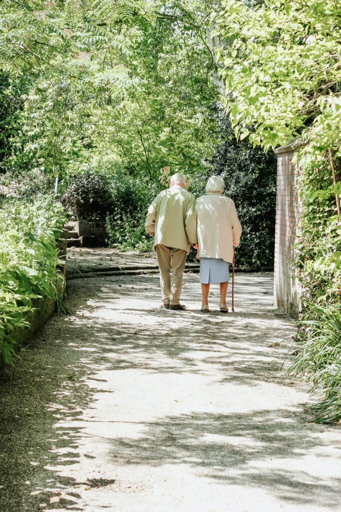 Elderly Couple Strolling in a Scenic Park